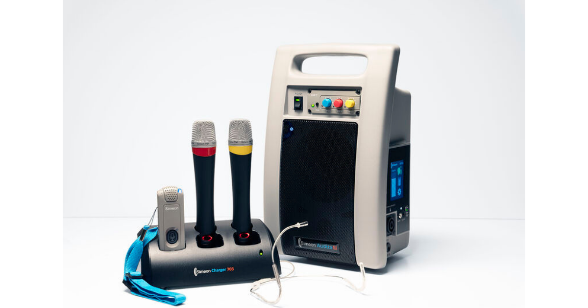 Simeon Audita III portable classroom audio system with two handheld microphones, a wearable microphone, charging station and headset microphone.