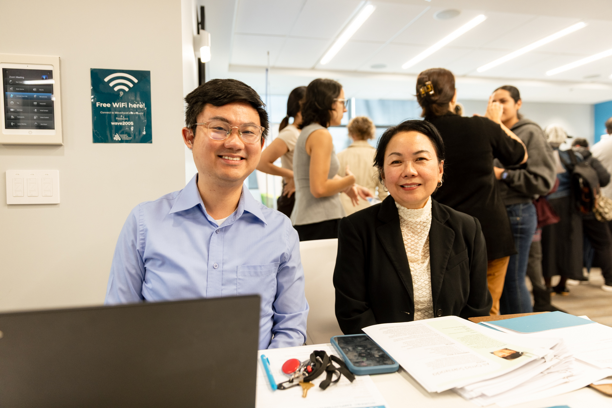 Two employer representatives smile behind an information table at Wavefront Centre’s 2026 Job Fair.