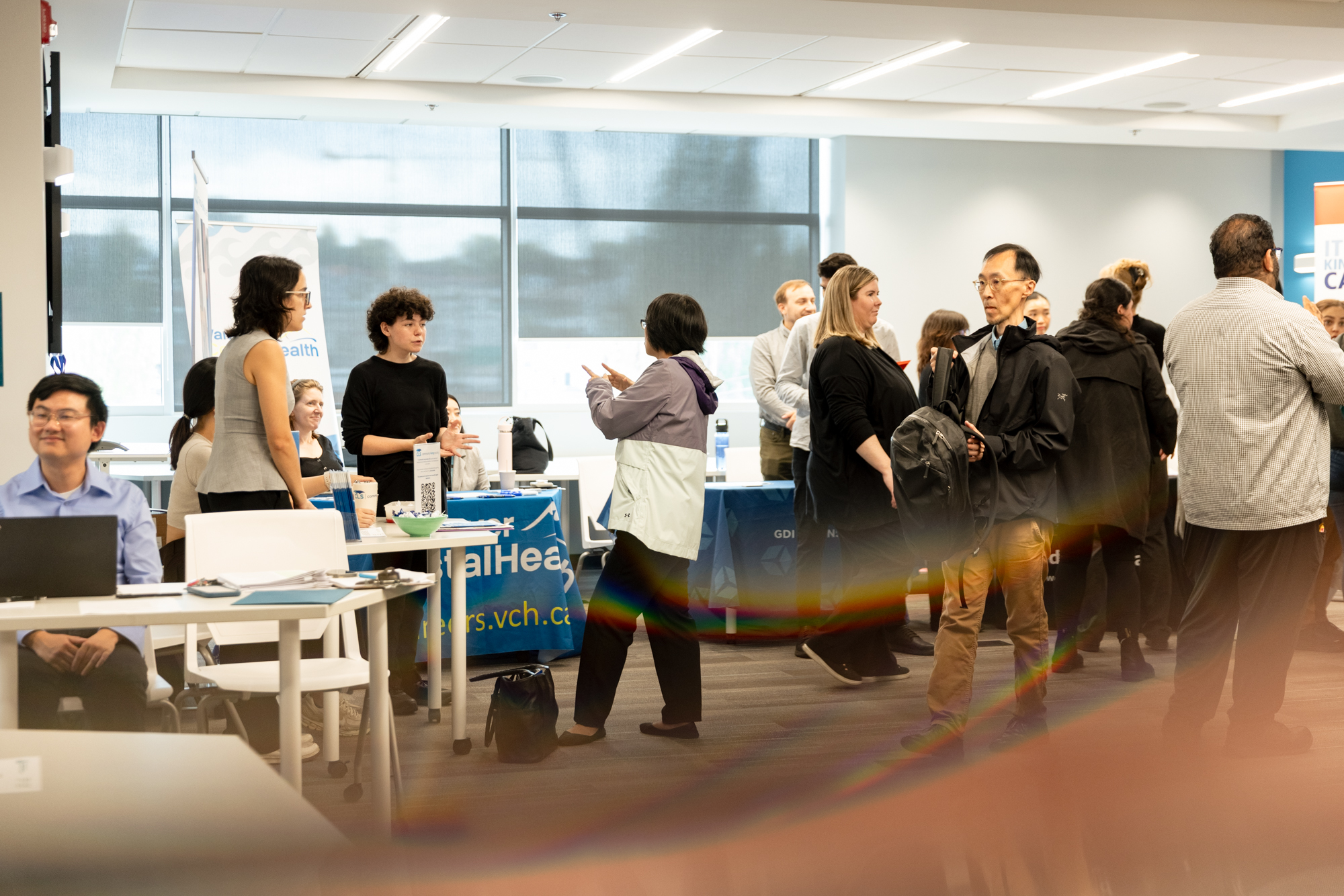 Job seekers and employer representatives converse at information tables during Wavefront Centre’s 2026 Job Fair.